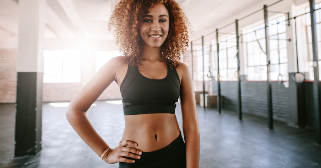 A woman poses at the gym.